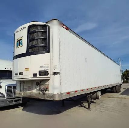 Thermo King reefer unit on the nose of a white refrigerated trailer